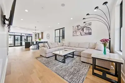 a living room with a couch and a table at Jungle House Luxury Homes - Columbus Downtown Short North - Near Convention Center & Nationwide Arena - Sleeps up to 15 - Free Parking - Over 5,800 Five Stars in Columbus