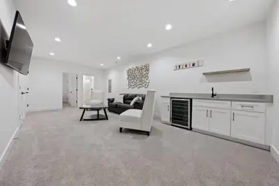 a white living room with a couch and a table at Jungle House Luxury Homes - Columbus Downtown Short North - Near Convention Center & Nationwide Arena - Sleeps up to 15 - Free Parking - Over 5,800 Five Stars in Columbus