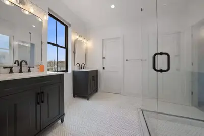 a bathroom with a sink and a shower with a glass door at Jungle House Luxury Homes - Columbus Downtown Short North - Near Convention Center & Nationwide Arena - Sleeps up to 15 - Free Parking - Over 5,800 Five Stars in Columbus