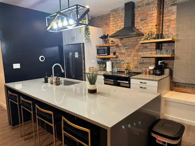 a kitchen with a large white island in a room at Jungle House Luxury Stays - Columbus Downtown Short North in Columbus