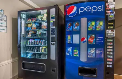 a pepsi vending machine is next to a wall at Extended Stay America Select Suites - Dayton - Miamisburg in Dayton