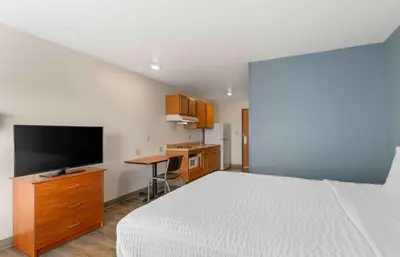 a bedroom with a bed and a desk with a television at Extended Stay America Select Suites - Dayton - Miamisburg in Dayton
