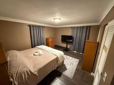 a small bedroom with a bed and a television at The Gather Grove in Toledo