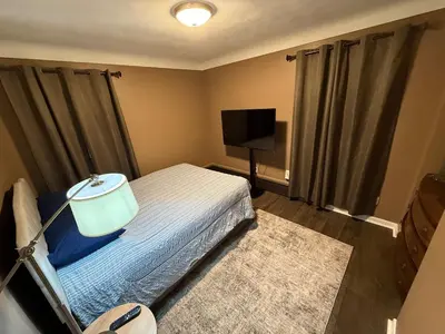 a bedroom with a bed and a flat screen tv at The Gather Grove in Toledo
