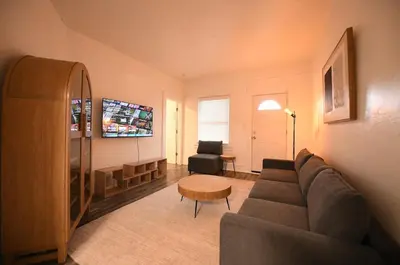 a living room with a couch and a table at Edgewater Stay on W78th in Cleveland