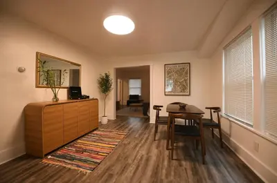 a living room with a table and a dining room at Edgewater Stay on W78th in Cleveland