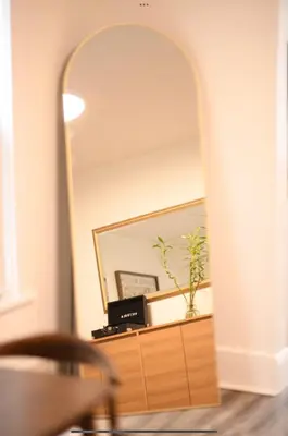 a mirror on top of a dresser in a room at Edgewater Stay on W78th in Cleveland