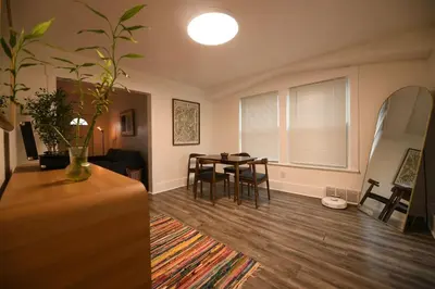 a living room with a table and a dining room at Edgewater Stay on W78th in Cleveland