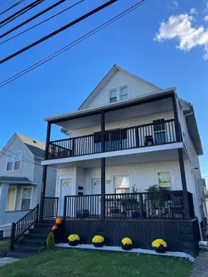 a white house with a balcony at Edgewater Stay on W78th in Cleveland
