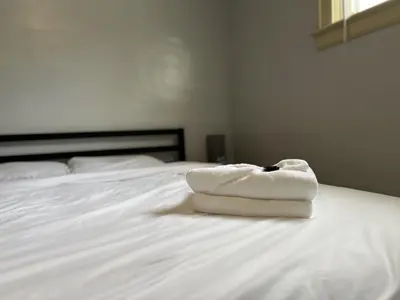a white towel sitting on top of a bed at Great Room near Cleveland airport in Cleveland