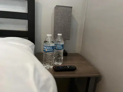 two bottles of water on a table next to a bed at Great Room near Cleveland airport in Cleveland