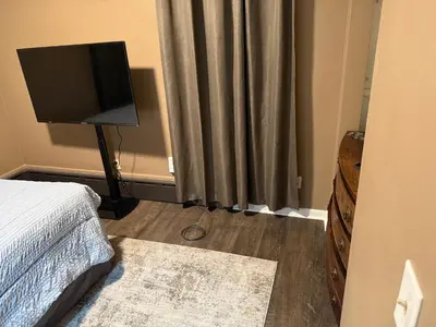 a bedroom with a bed and a television on a floor at The Unity Hub in Toledo