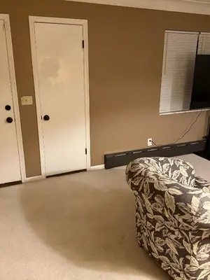 an empty room with a bed and a door at The Unity Hub in Toledo