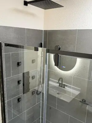 a bathroom with a shower and a sink at The Unity Hub in Toledo