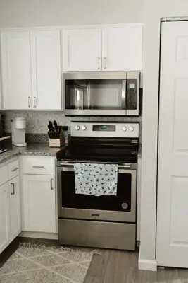 a kitchen with a stainless steel oven with a microwave at Mid Ohio Comfort 10 Minutes From Snow Trails in Lexington