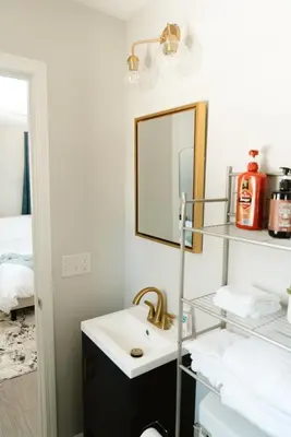 a bathroom with a sink and a mirror at Mid Ohio Comfort 10 Minutes From Snow Trails in Lexington