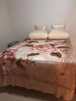 a bed with two pillows on top of it at Downstairs oasis