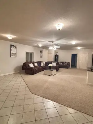 a living room with a couch and a table at Downstairs oasis