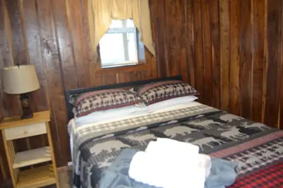 a bedroom with a bed and a window at Restful River Cabin, Red River Gorge, KY, River Access & Views in Stanton