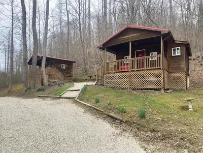 a small cabin in the woods with a driveway at Campfire Cabin, Red River Gorge, KY, River Access & Views in Stanton