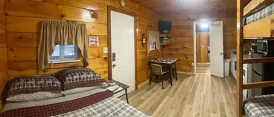 a living room with a couch in a log cabin at Sleepy Bear Cabin, Red River Gorge, KY, River Access & Views in Stanton