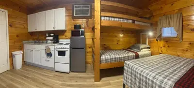 a kitchen with two beds in a wooden cabin at Sleepy Bear Cabin, Red River Gorge, KY, River Access & Views in Stanton