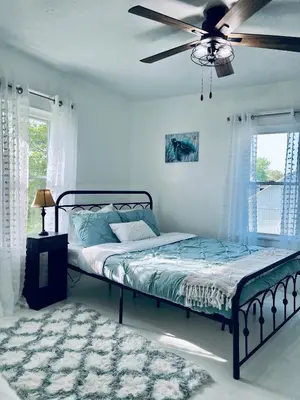 a bedroom with a bed and a ceiling fan at Scippo Creek Farm in Circleville