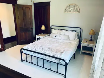 a bed in a bedroom with two night stands and two lamps at Scippo Creek Farm in Circleville