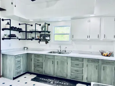 a kitchen with white cabinets and a sink at Scippo Creek Farm in Circleville