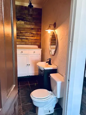 a bathroom with a toilet and a sink at Scippo Creek Farm in Circleville