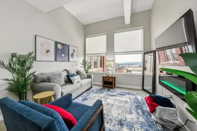 a living room with a couch and a table at Walk to Bengal, Reds Free Parking King Bed Gym in Cincinnati