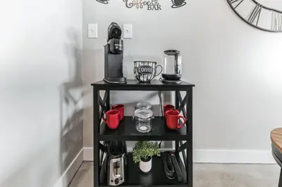 a black shelf with a coffee maker on it at Walk to Bengal, Reds Free Parking King Bed Gym in Cincinnati