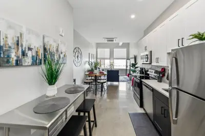 a kitchen with two tables and a refrigerator at Walk to Bengal, Reds Free Parking King Bed Gym in Cincinnati