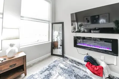 a living room with a fireplace and a tv at Walk to Bengal, Reds Free Parking King Bed Gym in Cincinnati