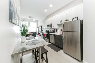 a large kitchen with a stainless steel refrigerator at Walk to Bengal, Reds Free Parking King Bed Gym in Cincinnati