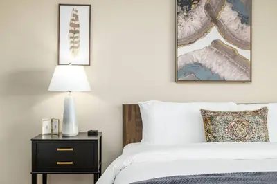 a bedroom with a bed and a nightstand with a lamp at The New Albany Perch Top Floor Pet-Friendly! in Westerville