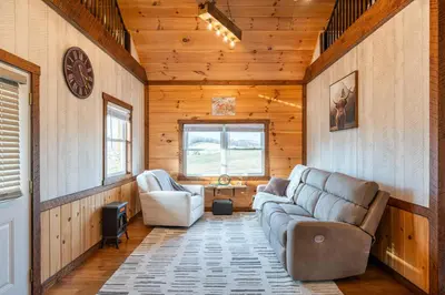 a living room with a couch and two chairs at Peaceful Valley Retreat in Sugarcreek