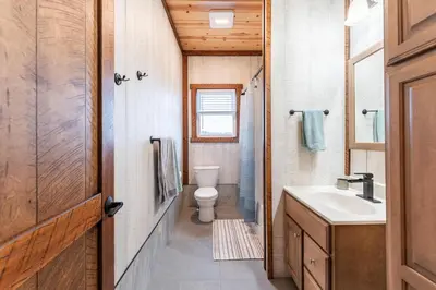 a bathroom with a toilet and a sink at Peaceful Valley Retreat in Sugarcreek