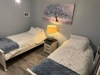 a bedroom with two beds and a lamp on a night stand at Pennsboro WV 'Country Roads' in Pennsboro