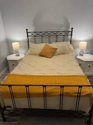 a bedroom with a bed with two nightstands and two lamps at Pennsboro WV 'Country Roads' in Pennsboro