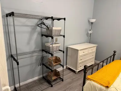 a room with a bed and a shelf with baskets at Pennsboro WV 'Country Roads' in Pennsboro