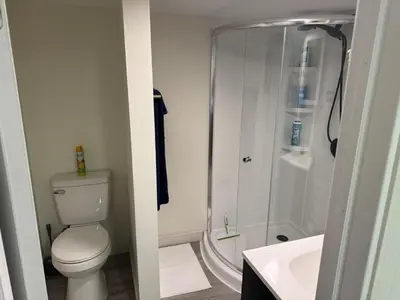 a bathroom with a shower and a toilet and a sink at Pennsboro WV 'Country Roads' in Pennsboro