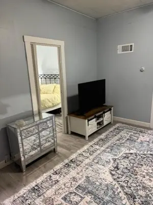 a living room with a television and a mirror at Pennsboro WV 'Country Roads' in Pennsboro