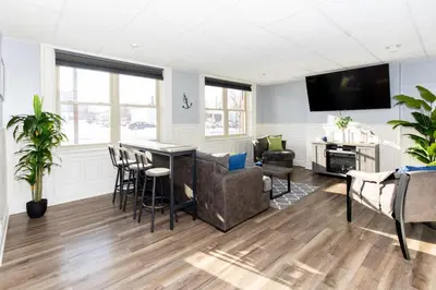 a living room with a couch and a table at Upgraded Downtown Apartment Sleeps 5 in Sandusky