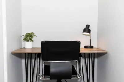 a desk with a black chair and a lamp at NEW! Remodeled & Upgraded Vacation Apartment in Sandusky