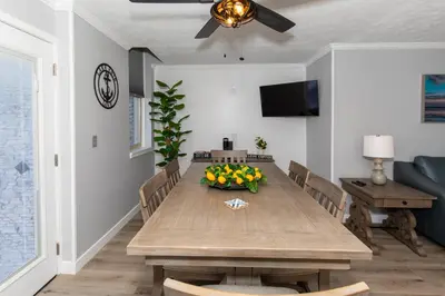 a dining room with a wooden table with a bowl of fruit at NEW! Remodeled & Upgraded Vacation Apartment in Sandusky