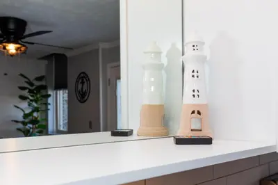 a counter top with two lighthouse figurines on it at NEW! Remodeled & Upgraded Vacation Apartment in Sandusky