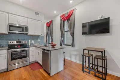 a kitchen with stainless steel appliances and a counter at OTR's Hidden Gem in Cincinnati