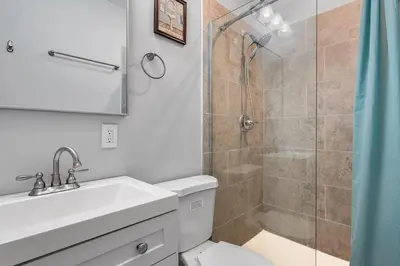 a bathroom with a shower and a toilet and a sink at OTR's Hidden Gem in Cincinnati