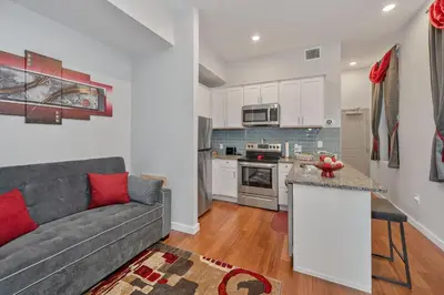 a living room with a couch and a kitchen at OTR's Hidden Gem in Cincinnati